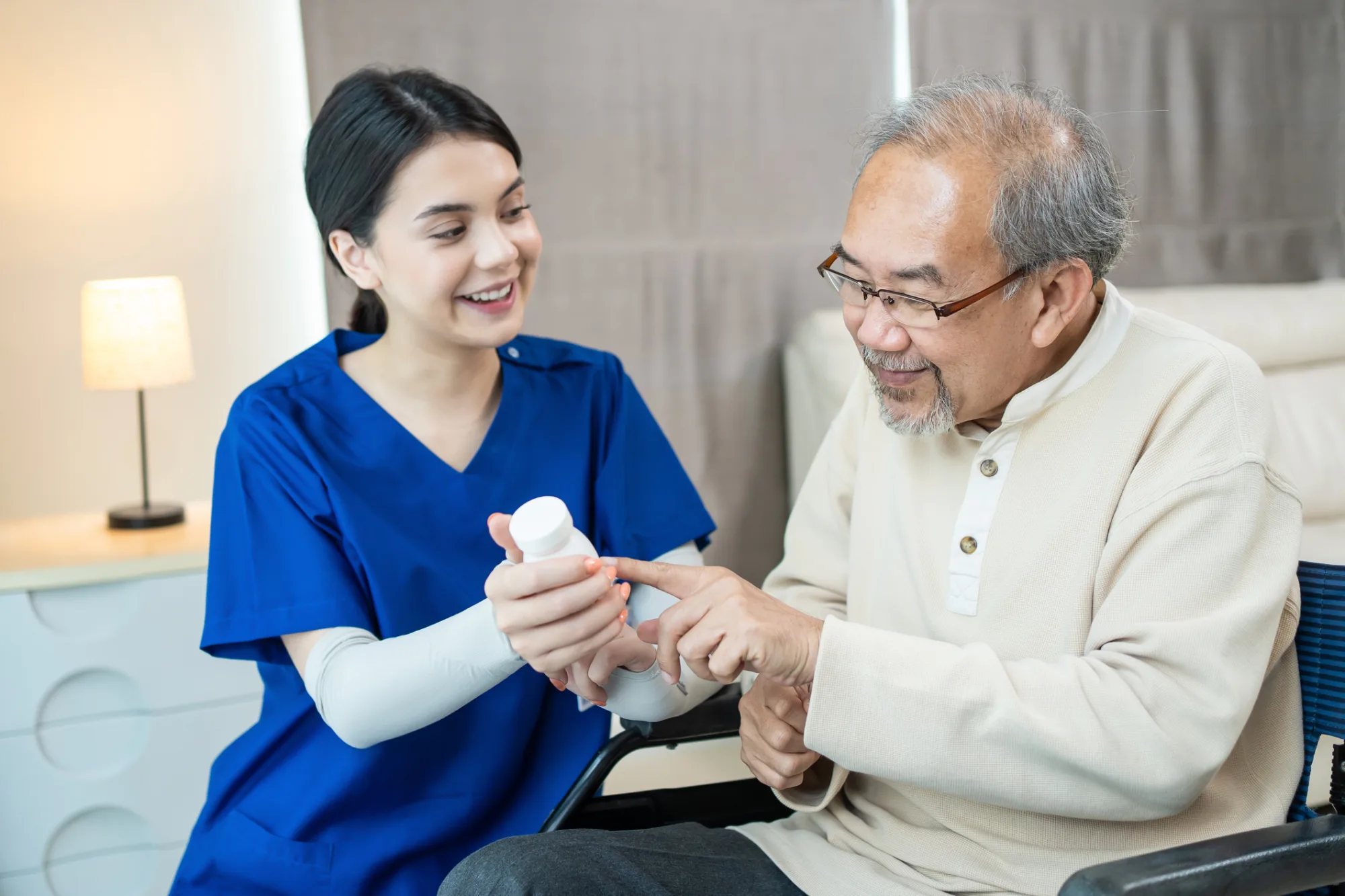 A nurse and an old man talking about a medication